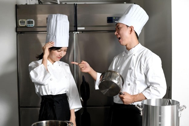 Seperti yang terlihat pada gambar, chef junior sedang dimarahi oleh seniornya